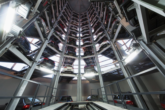 Several levels of platforms arranged in circle with cars