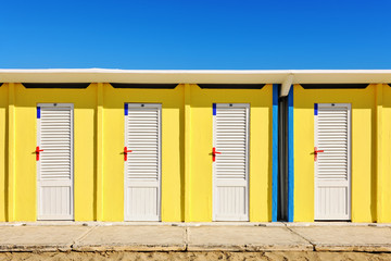 Bright yellow beach huts in Rimini
