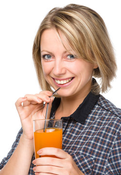 Young Woman Is Drinking Carrot Juice