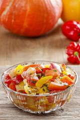 Fresh colorful vegetable salad in transparent glass bowl