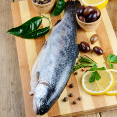Raw rainbow trout on the board