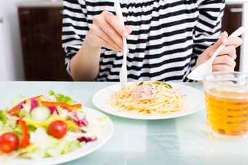 beautiful asian woman eating in the kitchen