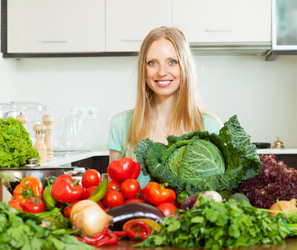   positive woman with pile of raw vegetables