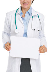 Closeup on smiling doctor woman showing blank paper sheet