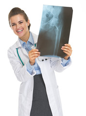 Smiling doctor woman looking out from fluorography