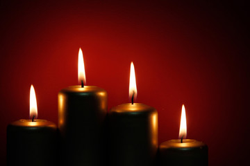 Four burning gold candles