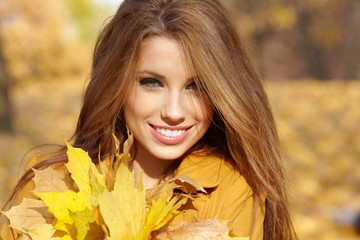 Beautiful autumn woman in golden park