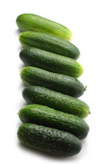 Fresh green cucumbers on white