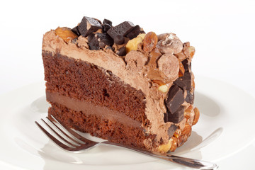 Fototapeta na wymiar Sweet chocolate cake topping with chocolate and almond nut
