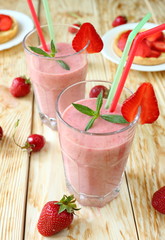 strawberry milk shake in a glass with a straw