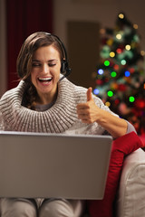 Happy young woman having video chat with family 