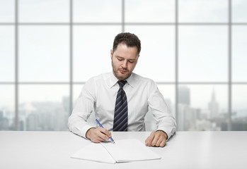 man writing on paper