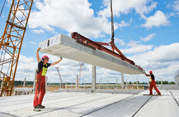 workers installing concrete slab