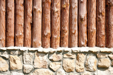 Vertical old wooden beams and a piece of the wall as texture