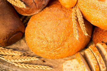 Homemade bread and wheat on the wooden table