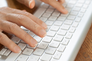 Male hands typing on the computer keyboard