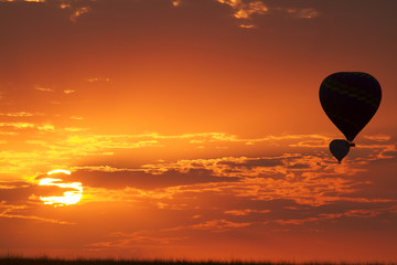 Balloons flying in early morning red sky