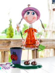 Cute smile doll with a beautiful basket on dining table