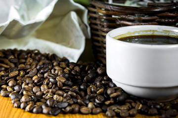 Coffee beans with a white cup