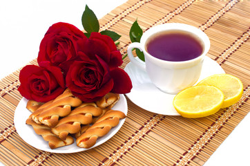 cup of tea with cookies and lemon