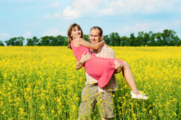 Naklejka na ściany i meble Happy man and woman in yellow meadow