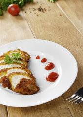 Fried chicken nuggets on the plate on the wooden table