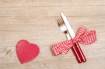 Messer und Gabel und rotes Herz mit weissen Punkten