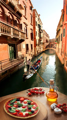 Venice with Italian pizza against canal in Italy
