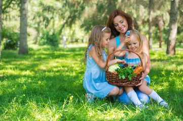 Obraz premium Mother with two daughters in the park