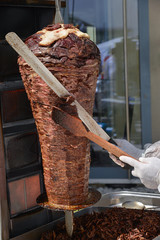 Chef slicing traditional Turkish food doner kebab