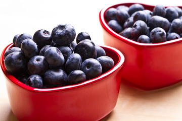 blueberries in a beautiful red heart-shaped bowls. full of vitam