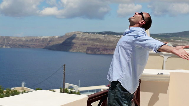 Young man enjoying beautiful view on terrace