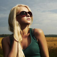 Beautiful blond girl on the field.beauty woman.sunglasses