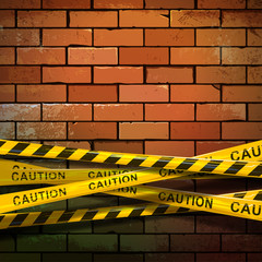 Caution ribbon on brick wall