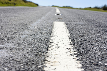 close up of the centre white line of a road