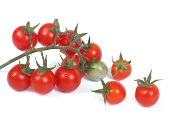 small branch of ripe cherry tomatoes isolated on a white