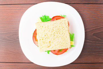 Fototapeta na wymiar Sandwich with ham, cheese and tomato