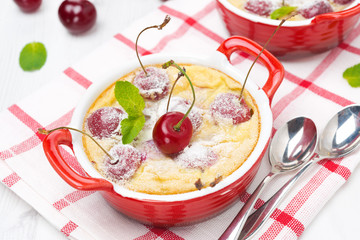 Casserole (clafoutis) with cherry in the ramekin, top view