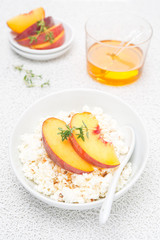 cottage cheese with honey, nuts and fresh peaches, top view