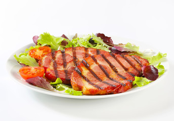 Grilled pork with salad greens