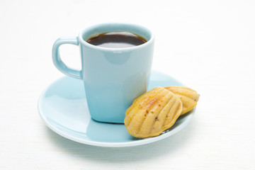 cup of coffee and madeleines cookies on a white background