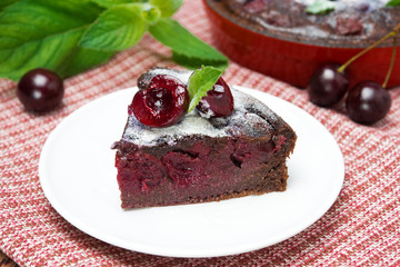 piece of chocolate Clafoutis with cherries and powdered sugar