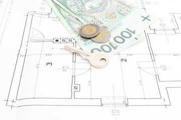 Money and silver key lying on the housing plan