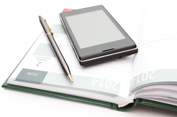 Modern mobile phone and pen lying on open calendar