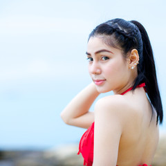 portrait of beautiful woman in red bikini on the beach