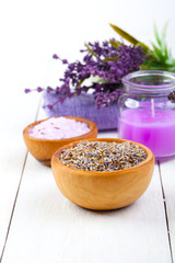 dry Lavender herbs, bath salt and candle, on white wooden table