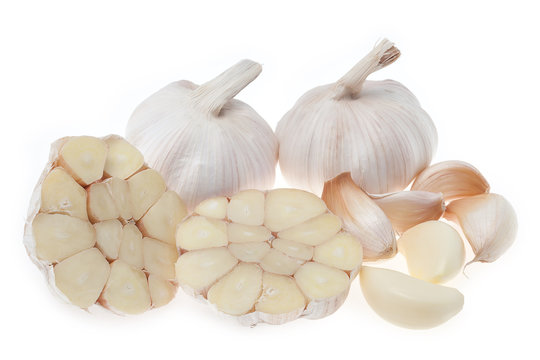 Group of garlic and showing cross section isolated on white