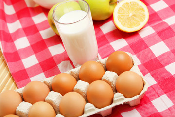 Milk in a glass jar and eggs