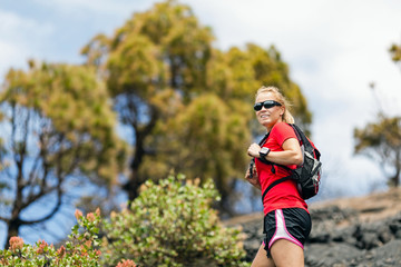 Fototapeta premium Hiking woman, runner in summer mountains