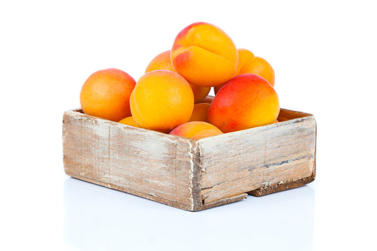 ripe apricots in wooden box, Isolated on white backgroun